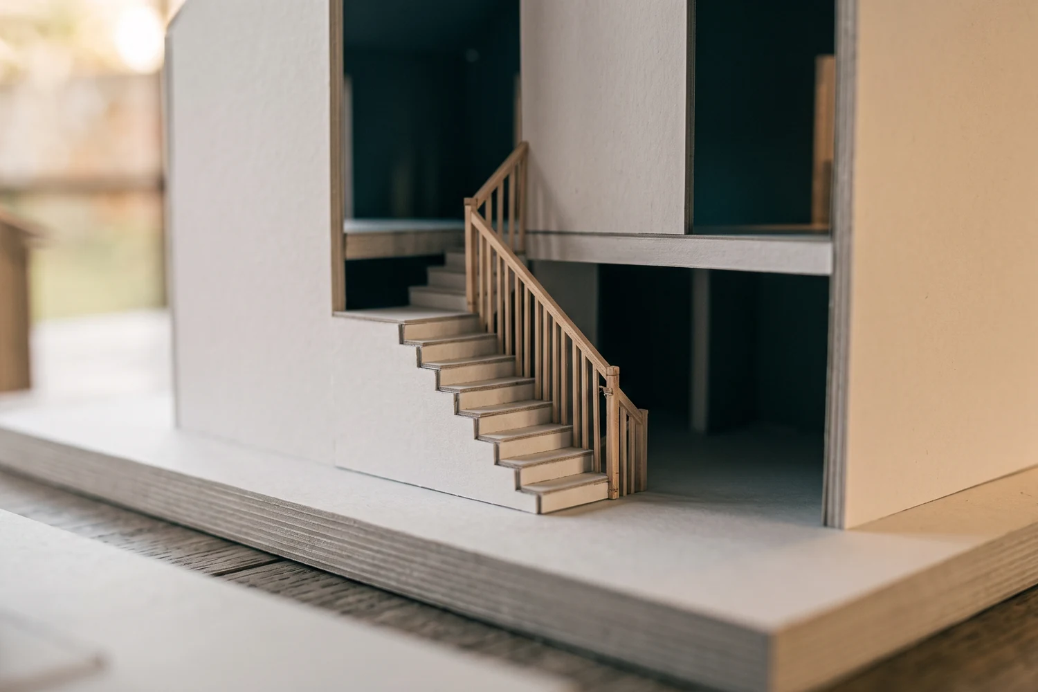 Détail d'une maquette d'architecture en carton blanc : escalier en coupe et garde-corps fin